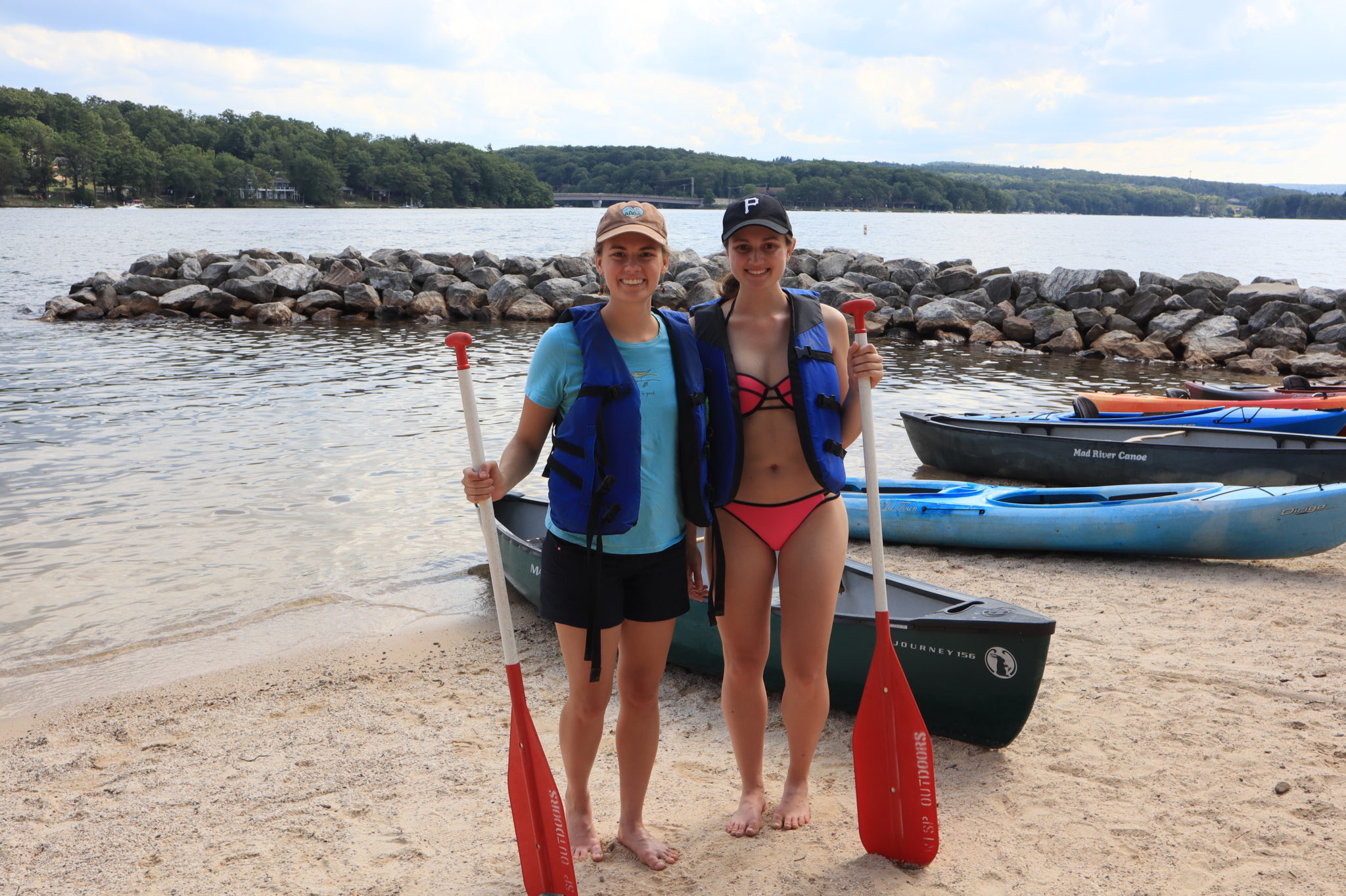 Two women standing in front of kayaks at Deep Creek Lake